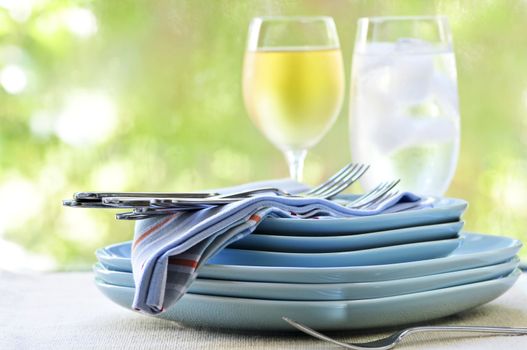 Table setting with stack of plates and cutlery