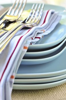 Table setting with stack of plates and cutlery