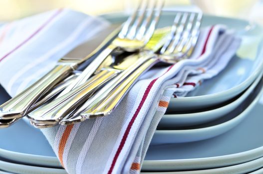 Table setting with stack of plates and cutlery