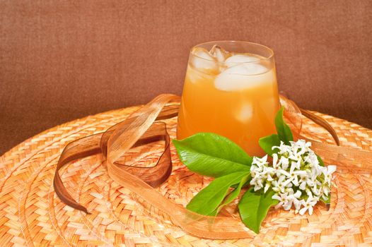 Drink with ice on colored background and contrasting