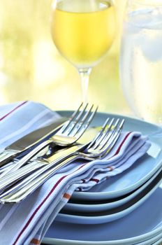 Table setting with stack of plates and cutlery