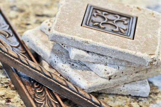 Ceramic tiles and borders for backsplash close up on a granite surface