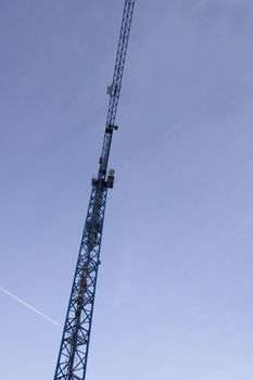 big blue crane on the sky background