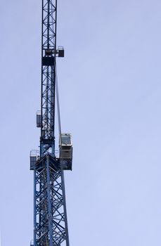 big blue crane on the sky background