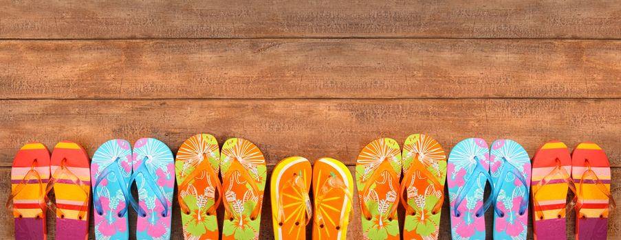 Brightly colored flip-flops on wood deck