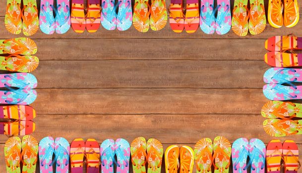 Brightly colored flip-flops on wood deck