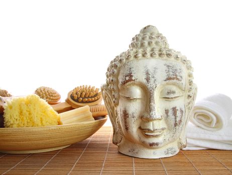 Bath accessories with buddha statue on white