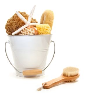White bucket filled with sponges, scrub brushes  on white