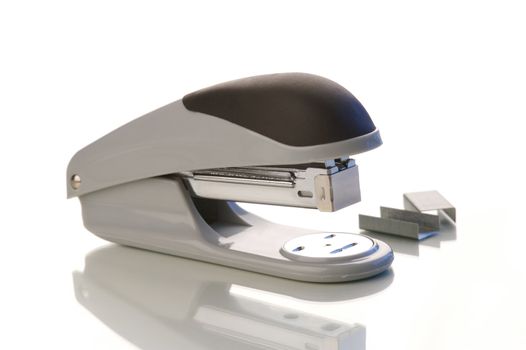 An office stapler on a white background