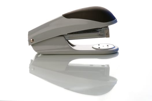 An office stapler on a white background