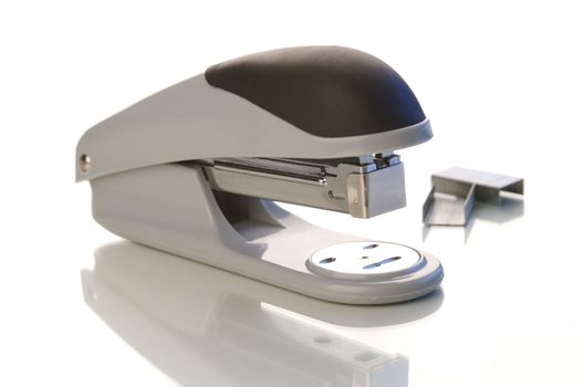 An office stapler on a white background