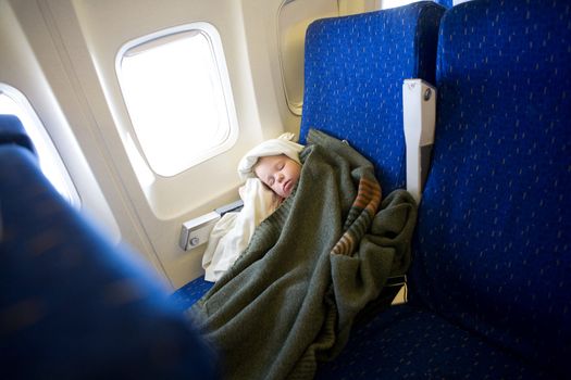 small girl sleeping in a plane