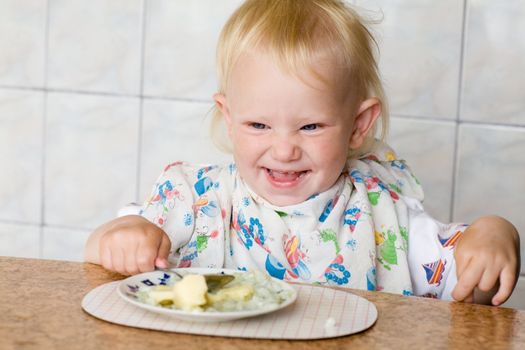 a small child eating porridge