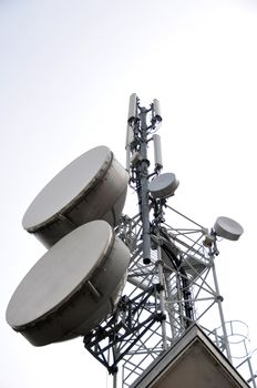 Communication tower with satellite dishes and aerials