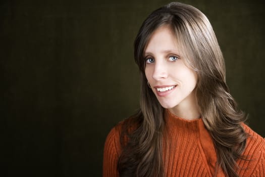 Pretty young woman wearing an orange sweater