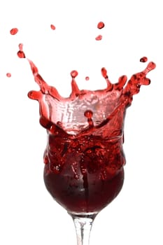 Goblet with splashing cherry juice isolated on white background with clipping path