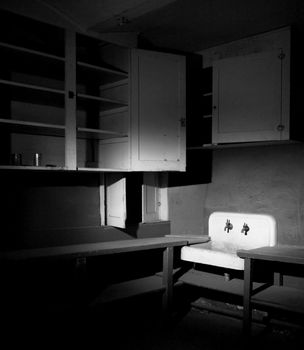Old Sink and Cabinets Inside a Condemned Building in Black and White