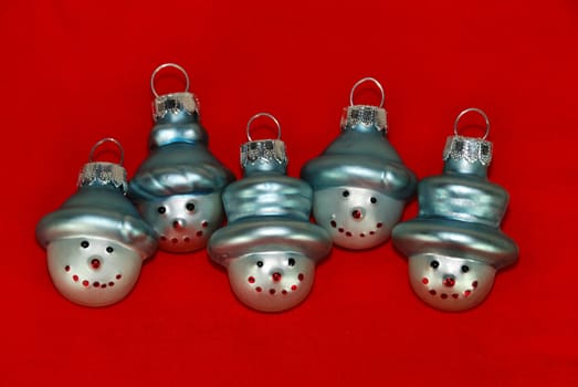 Five Christmas Tree Decoration Snowmen on Red Background