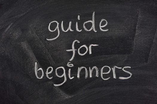 guide for beginners title handwritten with white chalk on a blackboard