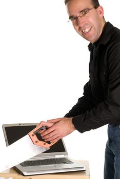 A man cutting his computer in half, isolated against a white background
