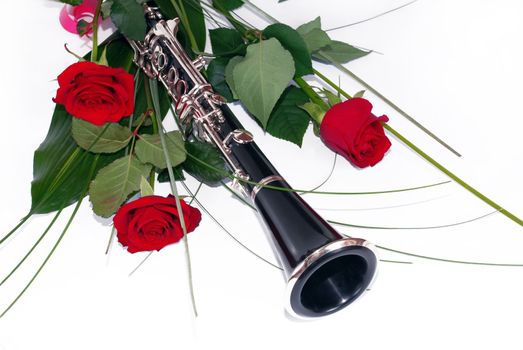 three red roses and clarinet composition over white