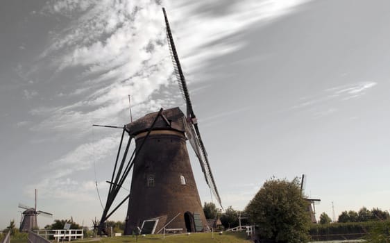 Dutch Windmill is blowing away soft clouds