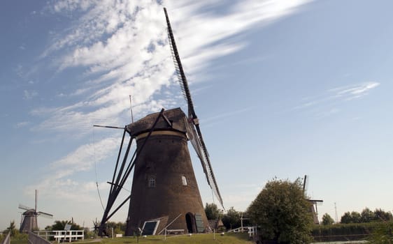 Dutch Windmill is blowing away soft clouds