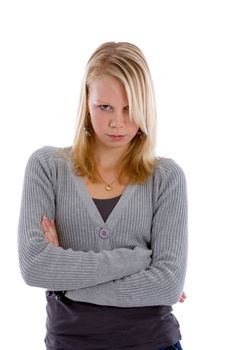 Pretty blond teenager with her arms crossed looking stubborn