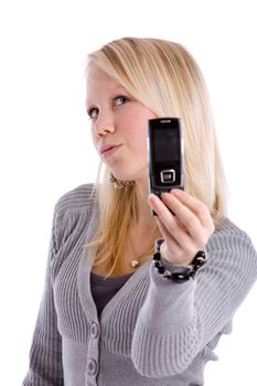 Young teenage girl posing for her own cameraphone