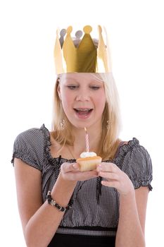 Happy blond teenager with braces and a birthday cake and candle