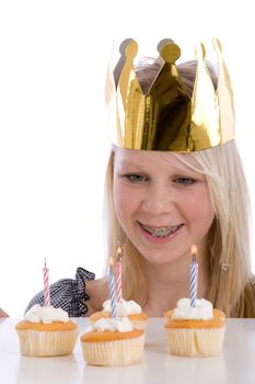 Cute young teenage girl with birthday candles on white