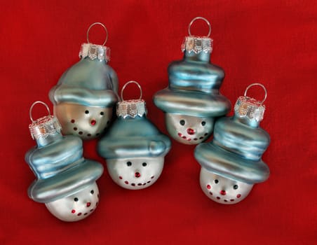 Five Christmas Tree Decoration Snowmen on Red Background