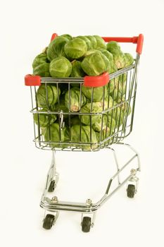 Brussels sprouts in a shopping trolley on white  background