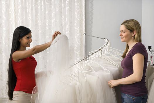 Indian woman and Caucasian woman shopping for veils.