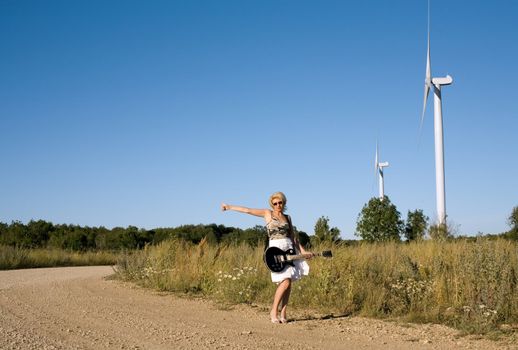 pretty blond with guitar hitch-hiking