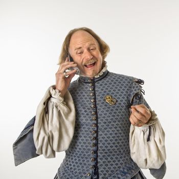 William Shakespeare in period clothing talking on cell phone.