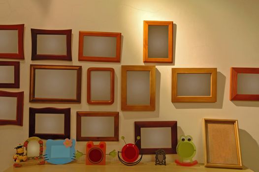 The photo frames hanging on a wall of a house