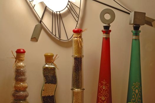 A row of decorative stylish bottles over white wall