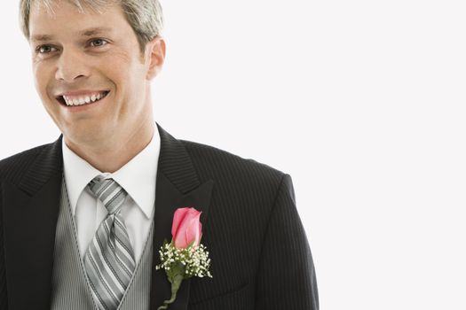 Portrait of Caucasian male in tuxedo with boutonniere.