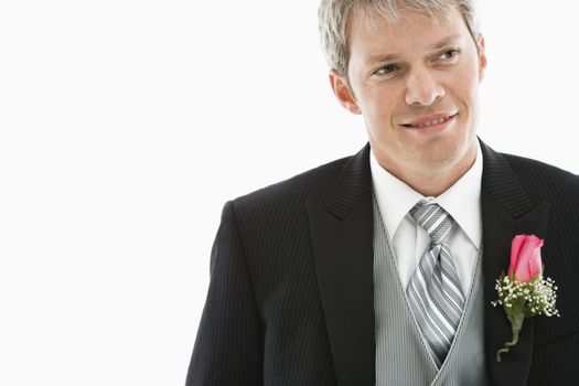 Portrait of Caucasian male in tuxedo with boutonniere.