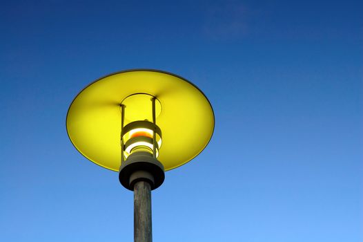 A close up of moderm street lamp over blue sky