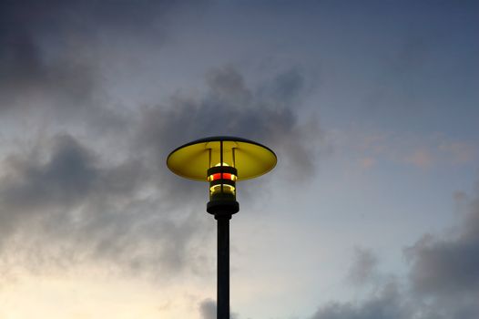 A moderm street lamp over the evening sky