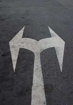 Left or right? Traffic sign on a tar road.