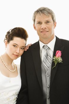 Portrait of Caucasian groom and Asian bride.