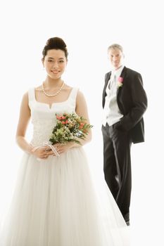 Portrait of Caucasian groom and Asian bride.