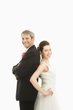 Portrait of Caucasian groom and Asian bride back to back.