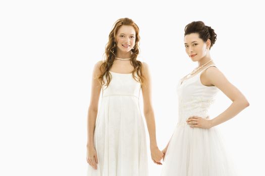 Asian bride holding Caucasian brides hand.