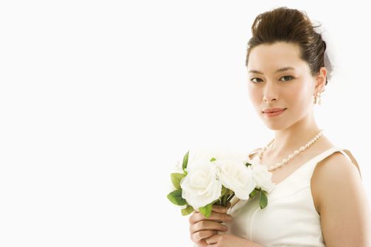 Portrait of Asian bride with bouquet.