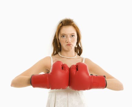 Caucasian bride with boxing gloves togther.