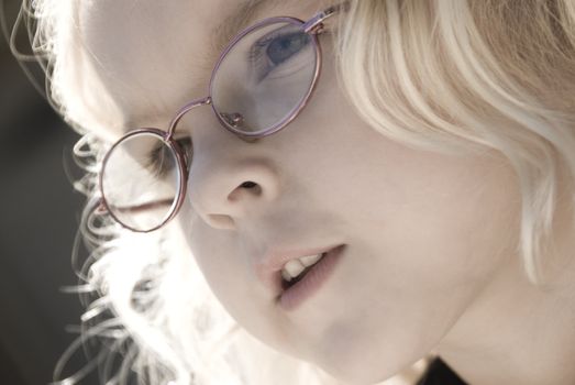 Soft Focus close up image of a child with glasses